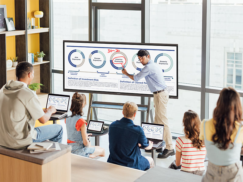 Teacher showing lesson materials on ViewBoard to students in a small-group space.